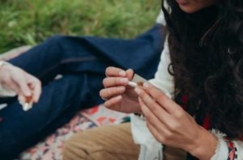 Girl rolling up cigarette - Addiction To Marijuana