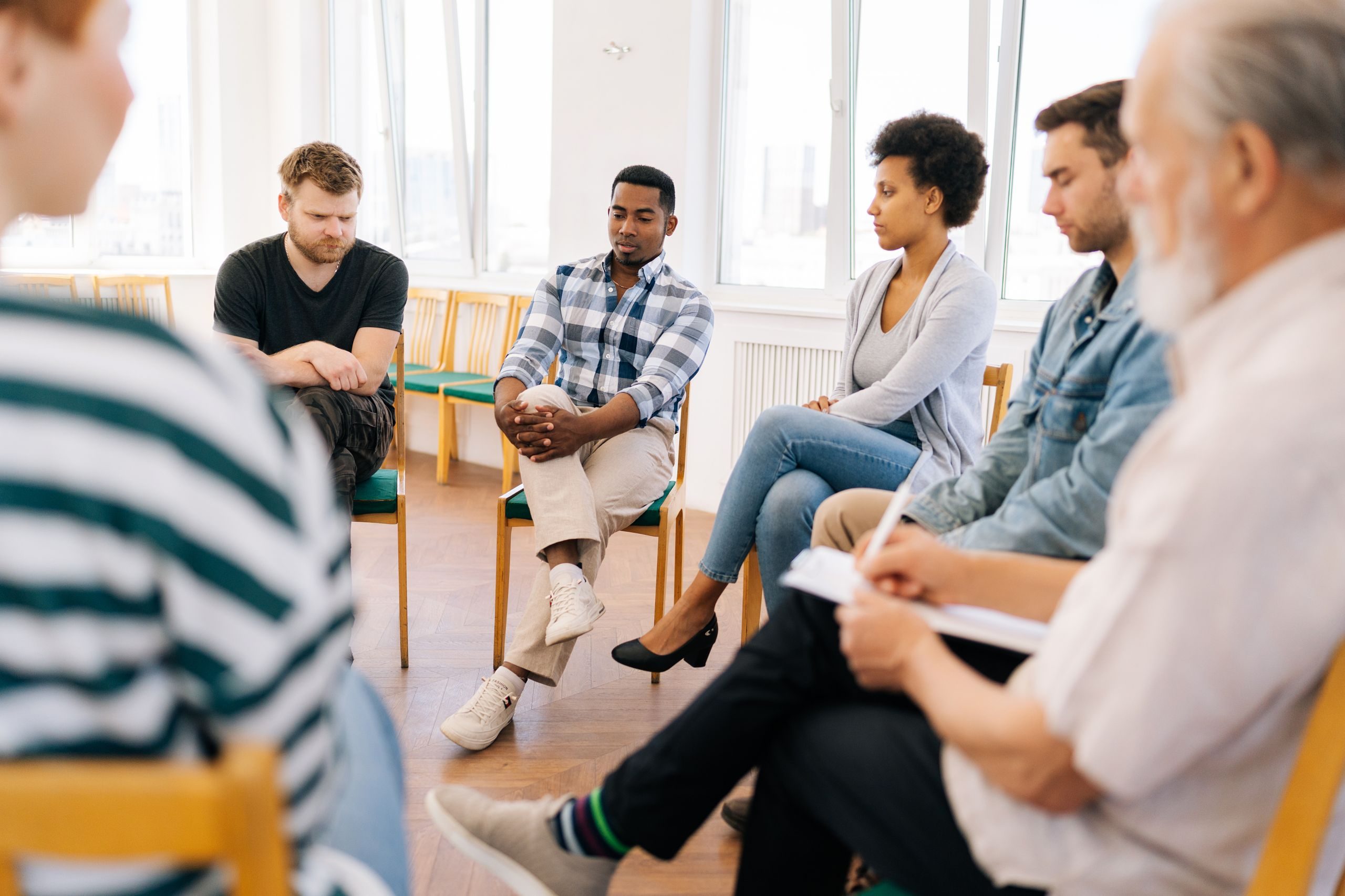 A group therapy session discussing Addiction and Mental Health