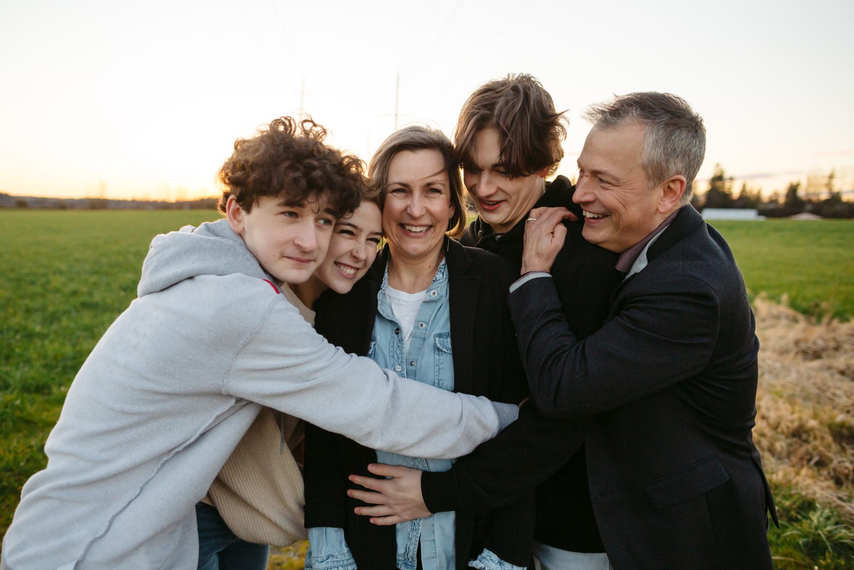 family laughing and hugging - family addiction treatment concept